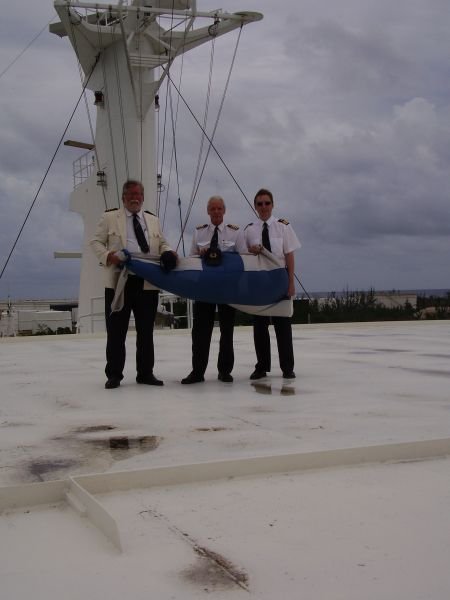 Captain Luciano Lullia, Chief Puonti and ? taking their hats off. Finns will board the vessel again in the spring of 2008 and in the summer of 2008, first to remove her gas turbines and then to evaluate her for potential buyers. Three groups visit the ship at Alang. One comprised of technical crew, one to make a commemorative visit and one more, where an unidentified person visited the ship briefly.